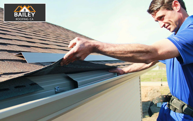 Professional roofer performing repairs on a slate roof to restore its durability and function.